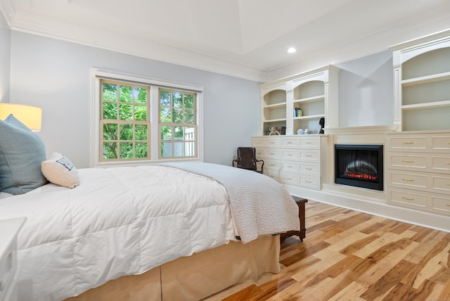 184 Stillson Rd Unit 184, Fairfield, CT 06825 - bedroom with ornamental molding, light wood-style flooring, a glass covered fireplace, and recessed lighting