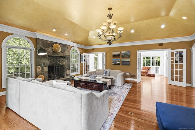 20 Pheasant Ln, Easton, CT 06612 - living area featuring ornamental molding, wood finished floors, a chandelier, a stone fireplace, and baseboards