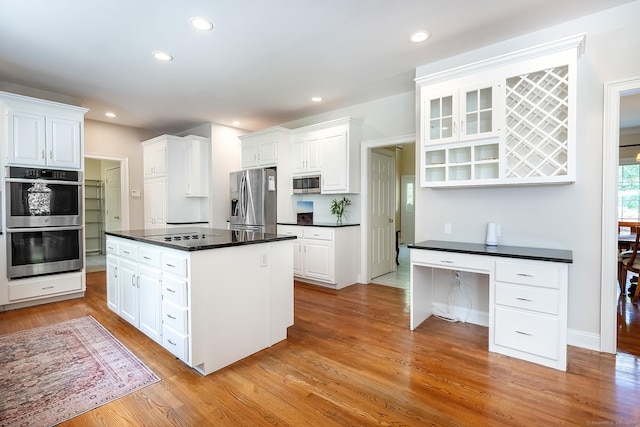 20 Pheasant Ln, Easton, CT 06612 - kitchen featuring appliances with stainless steel finishes, dark countertops, light wood finished floors, white cabinetry, and recessed lighting