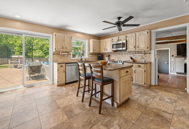 23 Lewis Rd, Preston, CT 06365 - kitchen with stainless steel appliances, a sink, backsplash, a kitchen island, and a breakfast bar area