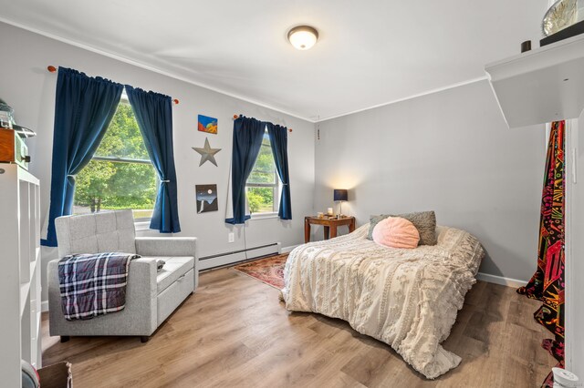23 Lewis Rd, Preston, CT 06365 - bedroom with baseboard heating, ornamental molding, wood finished floors, and baseboards