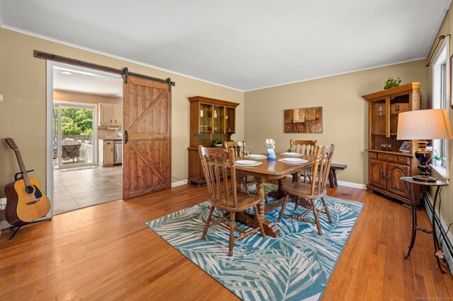 23 Lewis Rd, Preston, CT 06365 - dining area with a barn door, light wood-style flooring, ornamental molding, and baseboards