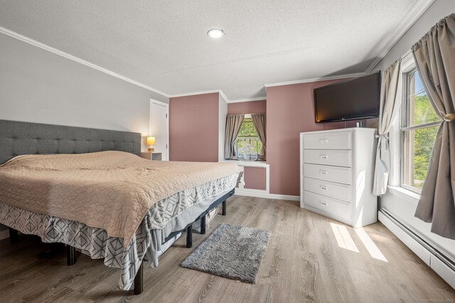 23 Lewis Rd, Preston, CT 06365 - bedroom with a baseboard heating unit, wood finished floors, ornamental molding, a textured ceiling, and baseboards