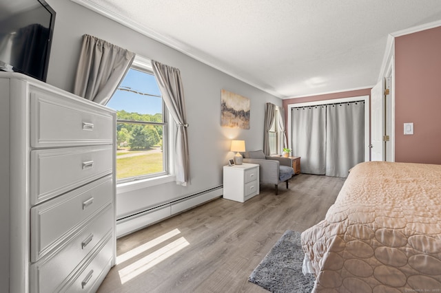 23 Lewis Rd, Preston, CT 06365 - bedroom with a baseboard radiator, crown molding, and light wood-type flooring