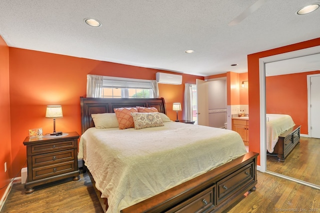 35 Summer St, Portland, CT 06480 - bedroom featuring wood finished floors, a wall mounted air conditioner, a textured ceiling, recessed lighting, and ensuite bathroom