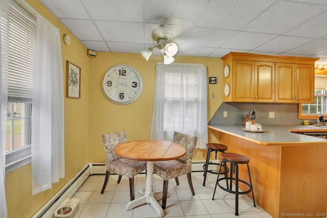 35 Summer St, Portland, CT 06480 - kitchen with a paneled ceiling, a baseboard radiator, ceiling fan, a breakfast bar area, and light countertops
