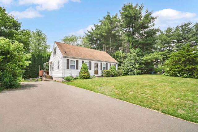 84 Wellman Rd, Manchester, CT 06040 - view of front of house featuring a front yard, asphalt driveway, view of scattered trees, and a shingled roof