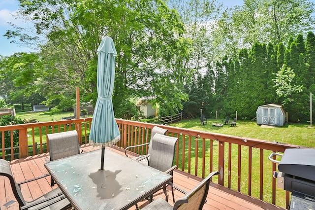 84 Wellman Rd, Manchester, CT 06040 - wooden deck with outdoor dining space, a shed, a lawn, and view of wooded area