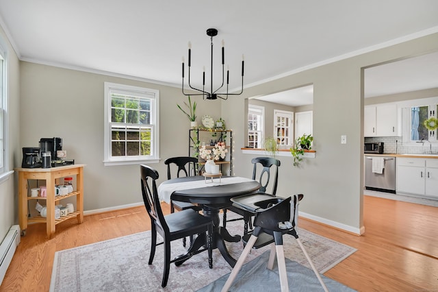 84 Wellman Rd, Manchester, CT 06040 - dining space with ornamental molding, light wood-style flooring, a baseboard radiator, and a chandelier