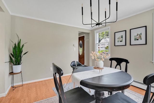 84 Wellman Rd, Manchester, CT 06040 - dining room with a chandelier, light wood-style flooring, a baseboard heating unit, and crown molding
