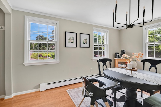 84 Wellman Rd, Manchester, CT 06040 - dining area featuring a chandelier, a baseboard radiator, crown molding, and light wood-type flooring