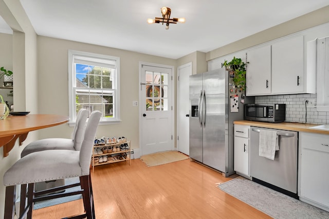 84 Wellman Rd, Manchester, CT 06040 - kitchen featuring appliances with stainless steel finishes, light wood-style flooring, and white cabinets