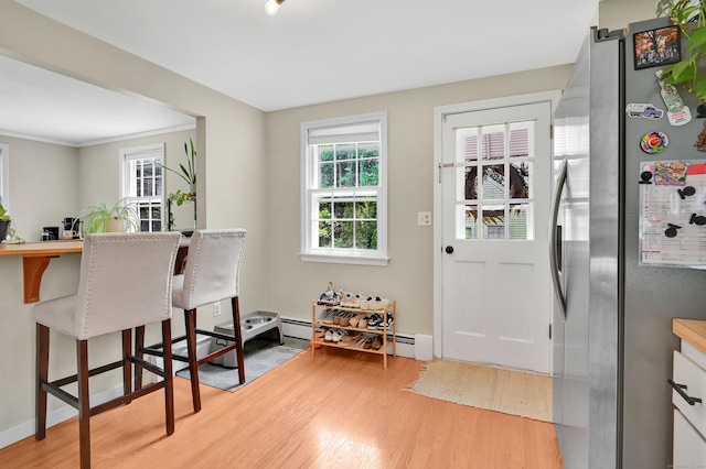 84 Wellman Rd, Manchester, CT 06040 - kitchen with freestanding refrigerator, light wood finished floors, plenty of natural light, and a breakfast bar area
