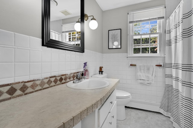 84 Wellman Rd, Manchester, CT 06040 - full bathroom featuring vanity, a baseboard heating unit, curtained shower, tile patterned flooring, and wainscoting