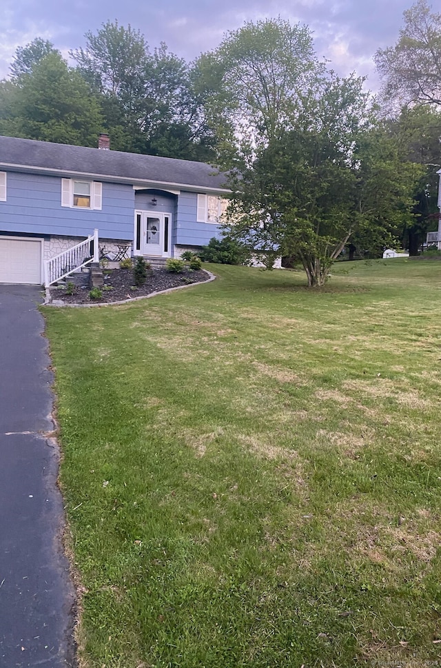 15 Brookhedge Rd, Trumbull, CT 06611 - split foyer home with a front yard, a chimney, driveway, and a garage