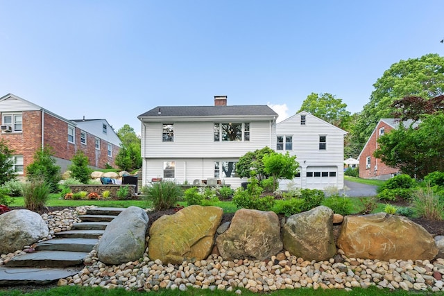 29 Fairwood Farms Dr, West Hartford, CT 06107 - back of house featuring a garage, a chimney, and asphalt driveway