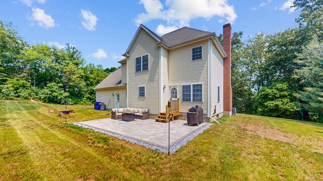 19 Heritage Brook Dr, East Haddam, CT 06423 - rear view of property featuring outdoor lounge area, a chimney, a patio, a yard, and central AC unit