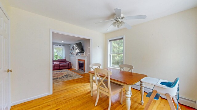 19 Heritage Brook Dr, East Haddam, CT 06423 - dining space featuring light wood-style floors, healthy amount of natural light, a brick fireplace, and a ceiling fan