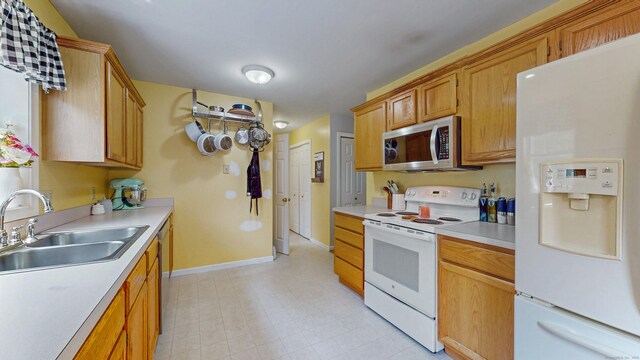 19 Heritage Brook Dr, East Haddam, CT 06423 - kitchen with white appliances, a sink, light countertops, and baseboards