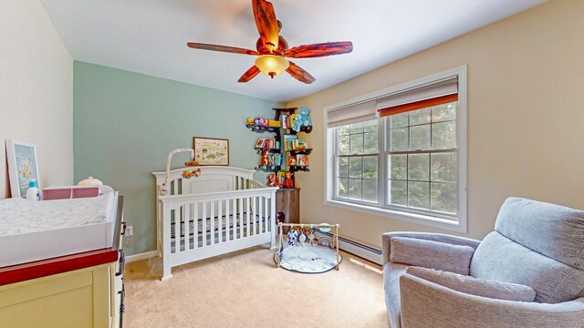 19 Heritage Brook Dr, East Haddam, CT 06423 - bedroom with baseboard heating, light colored carpet, a crib, ceiling fan, and baseboards