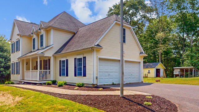 19 Heritage Brook Dr, East Haddam, CT 06423 - view of front facade featuring a porch, roof with shingles, asphalt driveway, a front lawn, and an attached garage