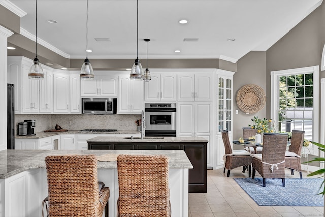 18 Cedar Spring Rd, Burlington, CT 06013 - kitchen featuring appliances with stainless steel finishes, a center island with sink, tasteful backsplash, a sink, and white cabinets