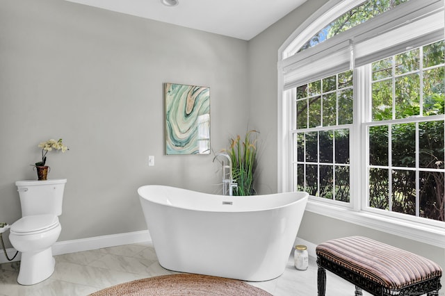 18 Cedar Spring Rd, Burlington, CT 06013 - full bathroom with a freestanding bath, marble finish flooring, baseboards, and toilet