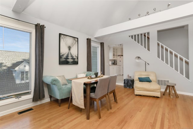 21 Hubbard Rd Apt 1, Wilton, CT 06897 - dining area featuring light wood-style flooring, stairs, and high vaulted ceiling