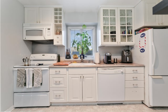 21 Hubbard Rd Apt 1, Wilton, CT 06897 - kitchen featuring white appliances, white cabinets, glass insert cabinets, light countertops, and ventilation hood