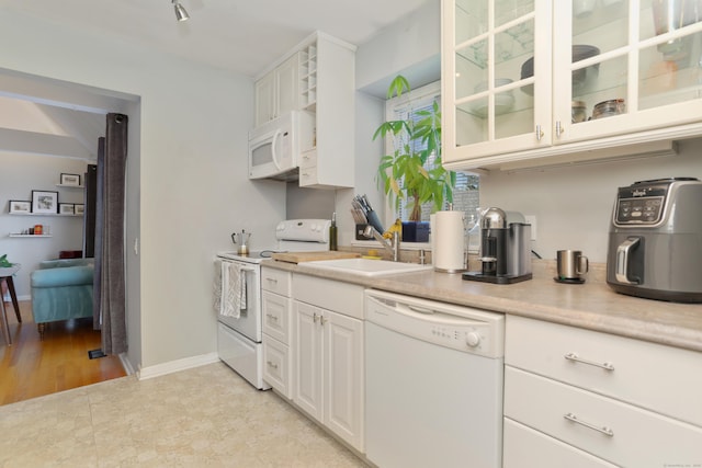 21 Hubbard Rd Apt 1, Wilton, CT 06897 - kitchen featuring white appliances, light countertops, glass insert cabinets, and white cabinets