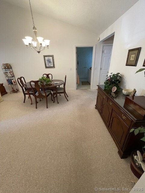 27 Shares Ln Unit 27, South Windsor, CT 06074 - dining space featuring a chandelier, light colored carpet, vaulted ceiling, and a textured ceiling