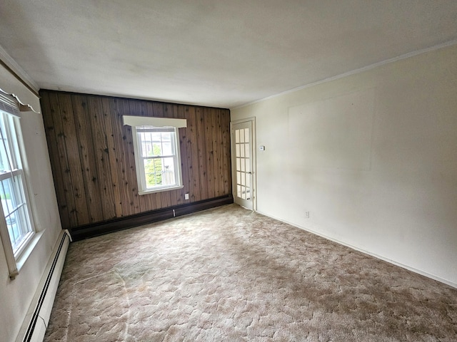 157 Garfield Rd, Bristol, CT 06010 - carpeted spare room featuring a baseboard heating unit, ornamental molding, wood walls, and baseboards