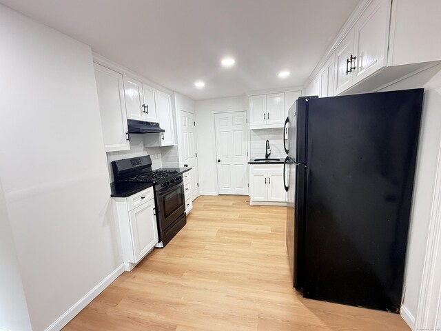 53 Cosey Beach Rd, East Haven, CT 06512 - kitchen featuring black appliances, under cabinet range hood, light wood-style floors, white cabinetry, and recessed lighting
