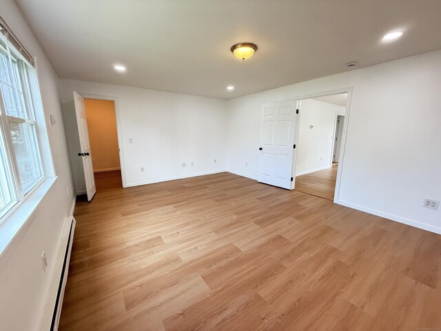 53 Cosey Beach Rd, East Haven, CT 06512 - spare room with a baseboard radiator, light wood-type flooring, recessed lighting, and baseboards