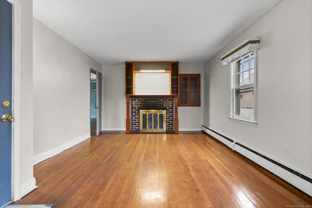 72 Maple St, Norwalk, CT 06850 - unfurnished living room with a baseboard radiator, hardwood / wood-style floors, and a brick fireplace