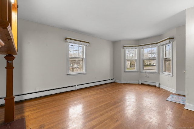 72 Maple St, Norwalk, CT 06850 - spare room with a baseboard radiator, baseboard heating, and hardwood / wood-style flooring