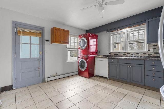 72 Maple St, Norwalk, CT 06850 - washroom with a baseboard heating unit, stacked washer / dryer, a ceiling fan, and light tile patterned flooring