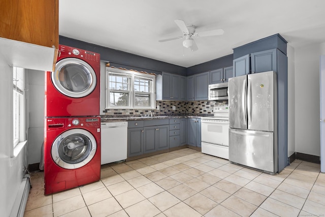72 Maple St, Norwalk, CT 06850 - kitchen featuring stainless steel appliances, estacked washer and dryer, a ceiling fan, backsplash, and a baseboard radiator