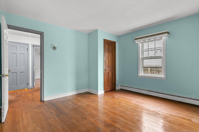72 Maple St, Norwalk, CT 06850 - empty room with baseboard heating and hardwood / wood-style flooring