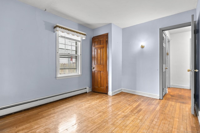 72 Maple St, Norwalk, CT 06850 - unfurnished room with a baseboard heating unit and light wood-style floors