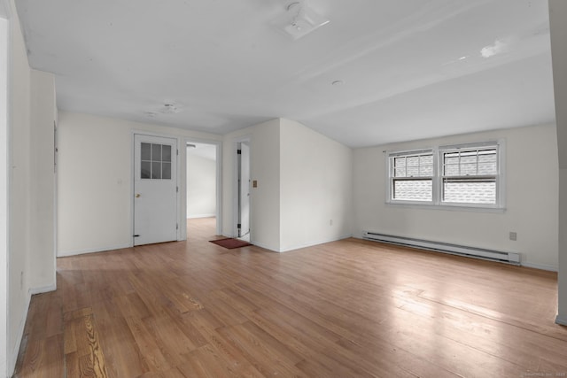 72 Maple St, Norwalk, CT 06850 - unfurnished room featuring a baseboard heating unit, light wood-style flooring, and lofted ceiling