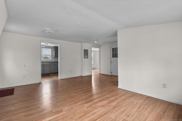 72 Maple St, Norwalk, CT 06850 - unfurnished living room with light wood-style floors, baseboard heating, and electric panel