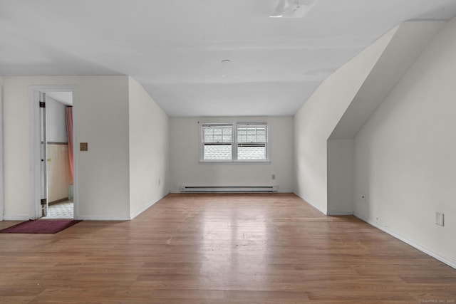 72 Maple St, Norwalk, CT 06850 - bonus room with a baseboard radiator, wood finished floors, and vaulted ceiling