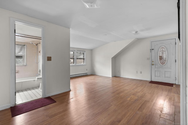 72 Maple St, Norwalk, CT 06850 - additional living space featuring a baseboard radiator, wood finished floors, and lofted ceiling