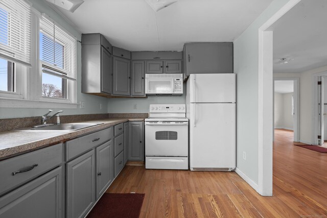 72 Maple St, Norwalk, CT 06850 - kitchen with white appliances, gray cabinetry, and light wood-type flooring