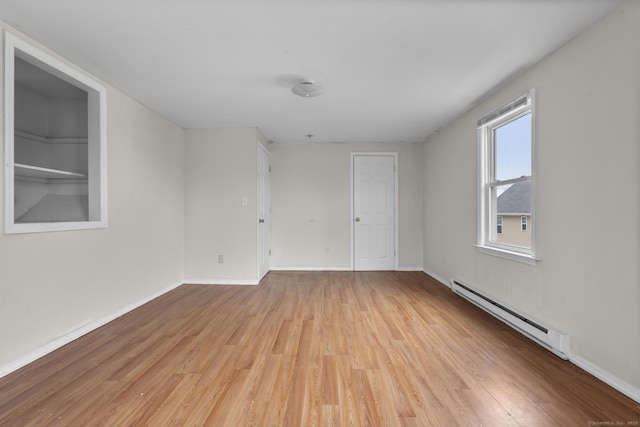 72 Maple St, Norwalk, CT 06850 - empty room with a baseboard heating unit and light wood-style flooring