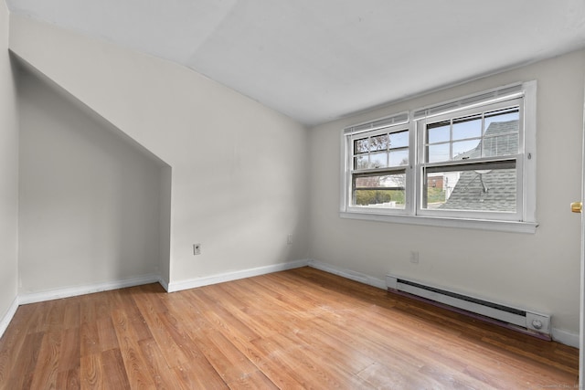 72 Maple St, Norwalk, CT 06850 - spare room with a baseboard radiator, lofted ceiling, and light wood-style floors