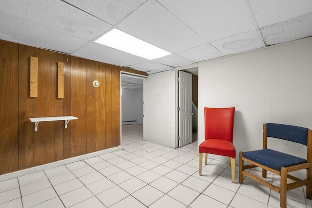 72 Maple St, Norwalk, CT 06850 - sitting room with a drop ceiling, a baseboard radiator, and wooden walls