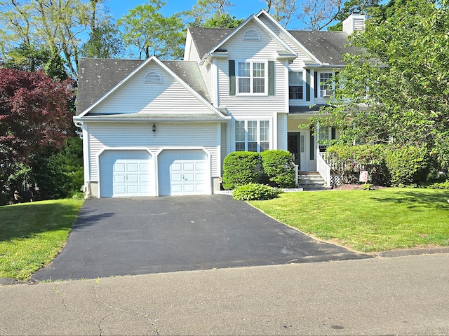 65 Ruby Ln, Stratford, CT 06614 - traditional-style home featuring a garage, asphalt driveway, and a front yard