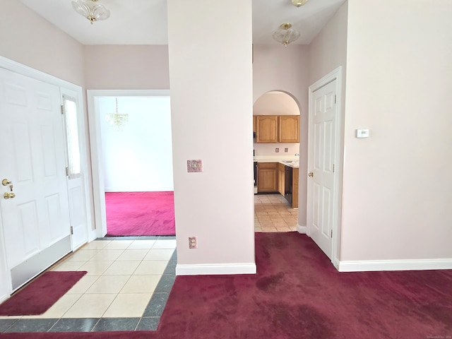 65 Ruby Ln, Stratford, CT 06614 - foyer entrance with light carpet, arched walkways, and light tile patterned floors